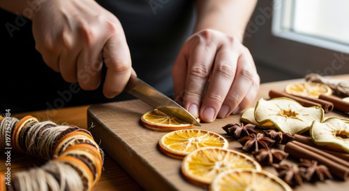 Hands Cutting Dried Orange Slices for Holiday Decorations on Wooden Board
