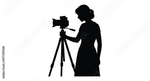 Woman photographing with a camera on a tripod striking black silhouette
