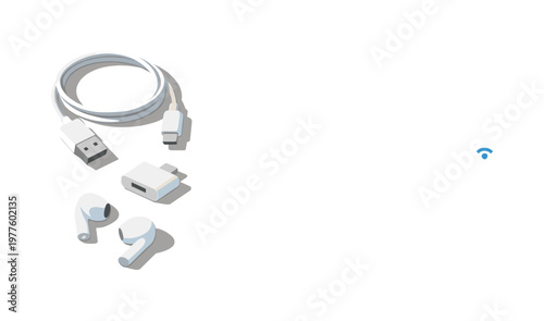 Minimal minimal tech accessories set with charging cable adapter and earbuds loosely arranged seen from a top-down angle, offset