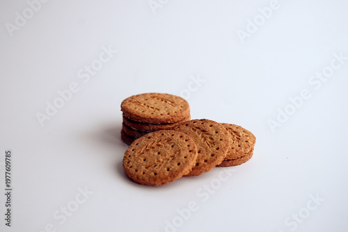 Stack of whole grain oatmeal cookies on light background.