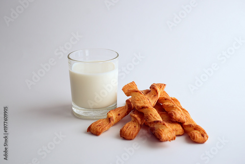 A glass of milk and puff pastry sticks, healthy nutrition.
