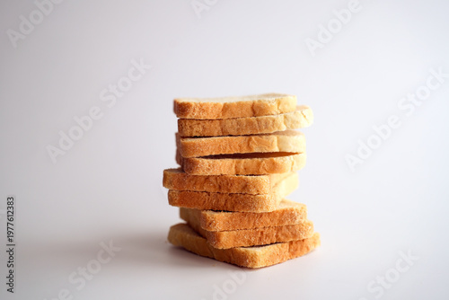Sliced white bread and crumbs on white background.