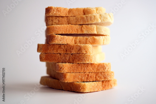 Sliced white bread and crumbs on white background.