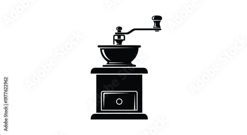Vintage coffee grinder displayed in a stark black silhouette