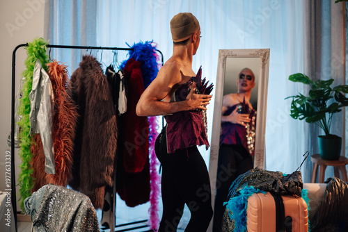 Принти на полотні Drag performer transforming in dressing room, trying on a costume, reflecting co
