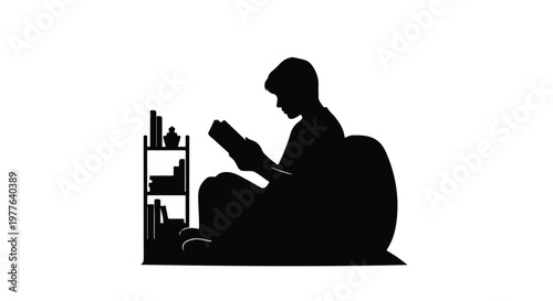 Silhouette of a person reading a book while sitting in a bean bag