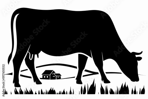 Silhouette of a cow grazing in a field with a small farmhouse