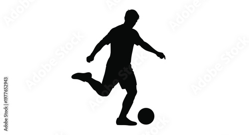 A dynamic soccer player in mid kick captured as a striking silhouette