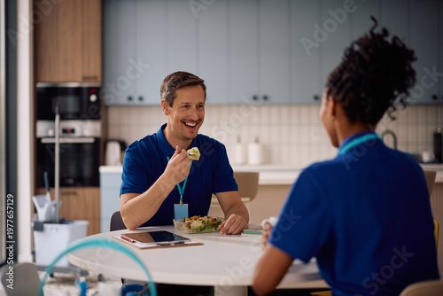 Fotografie Happy professional cleaner and his female coworker enjoying in lunch break