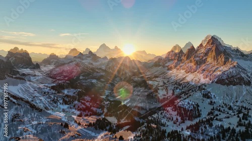 Majestic Mountain Range Sunrise Over Snowy Peaks.