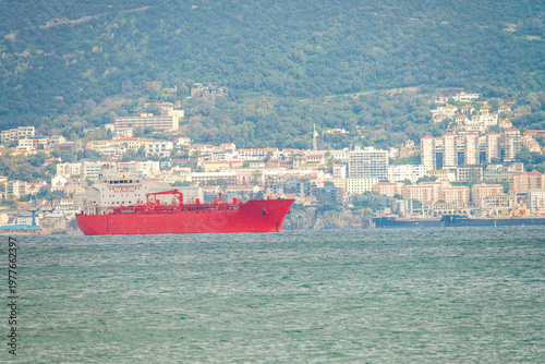 Red tanker ship in Algeciras Cadiz Spain with coastal cityscape