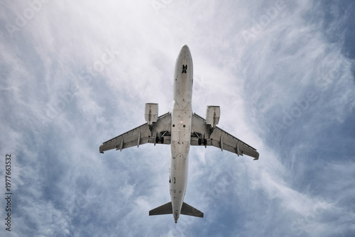 A huge passenger plane is landing in airport of Phuket, Thailand, a bottom view 
