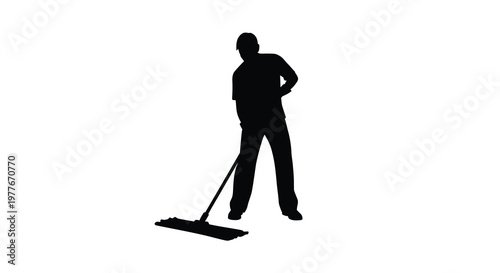 A lone worker uses a mop showcasing a striking black silhouette