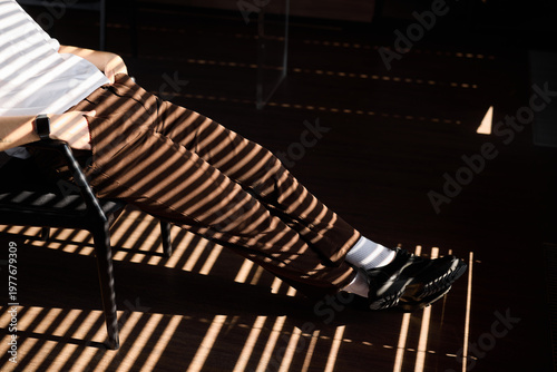 Sophisticated setting with shadows and polished footwear