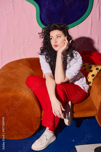 фотографія Woman in casual attire enjoys tranquil moment on vibrant furniture