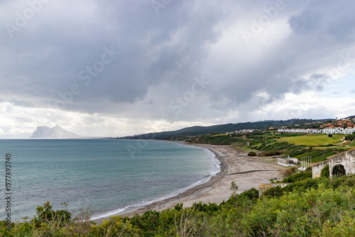 Seaside spanish landscape. La Alcaidesa urbanization on Costa del Sol, Andalusia Spain. Cadiz province. Gibraltar rock, british overseas territory on spanish coast.