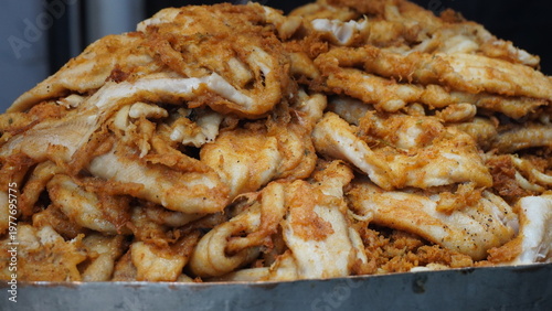 Crispy fried fish fillets piled high with golden texture, fried seafood concept