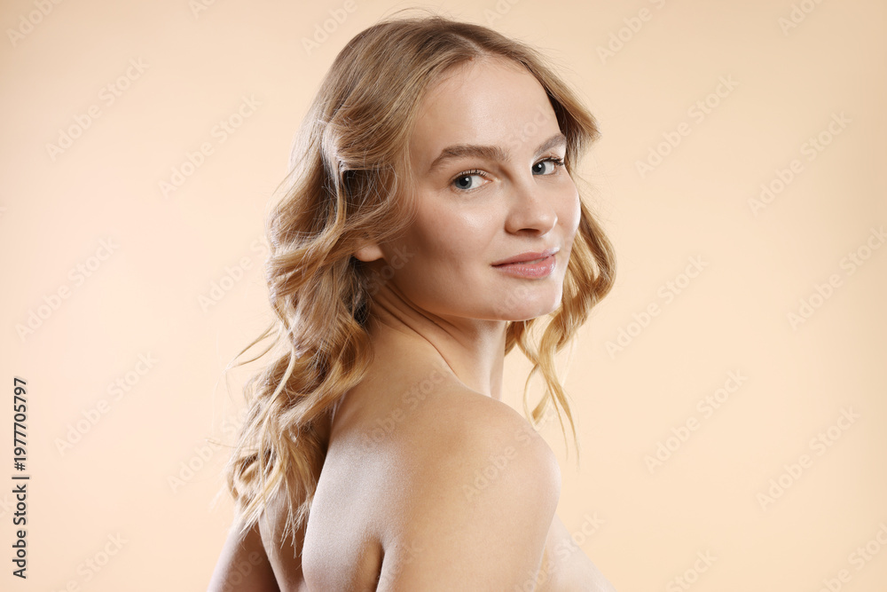 Naklejka premium Portrait of beautiful woman on beige background