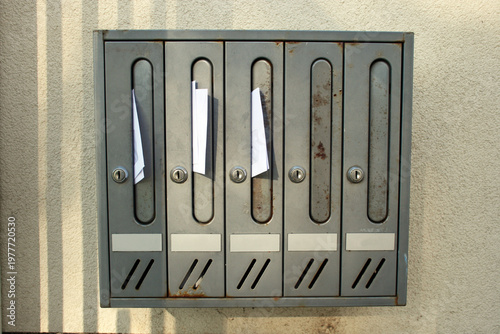 Mail boxes in the collective housing building with some letters