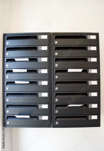 Mail boxes in the collective housing building with some letters