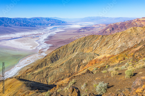 A high-detail close-up of the rough, white crystalline salt crust patterns covering the expansive floor of Badwater Basin in Death Valley.