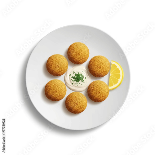 Delicious falafel balls served with creamy tahini sauce and a lemon wedge on a white plate, a popular Middle Eastern dish
