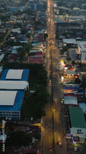 Wallpaper Mural City at night in Davao with busy highway and lights flicker. Davao City, Philippines. Mindanao. Vertical view. Torontodigital.ca