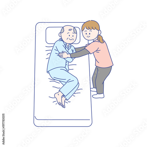 ベッド上での体位変換を行う介護士