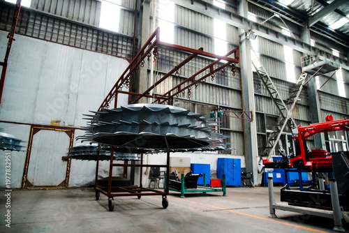 Fotografie Scene of agricultural machinery components in factory workshop