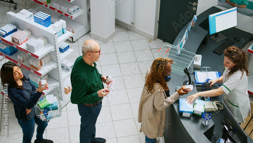 Foto Diverse customers waiting in line to pay for drugs or pills at pharmacy shop counter, having prescription medicine and needing supplements