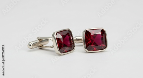 白い背景で美しく輝く深紅の宝石をあしらった洗練された銀色のカフスボタン豪華なメンズアクセサリー. AI Generated