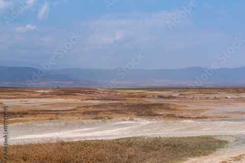 dry windswept floor of vast ngorongoro crater national park and mountains on horizon in tanzania africa
