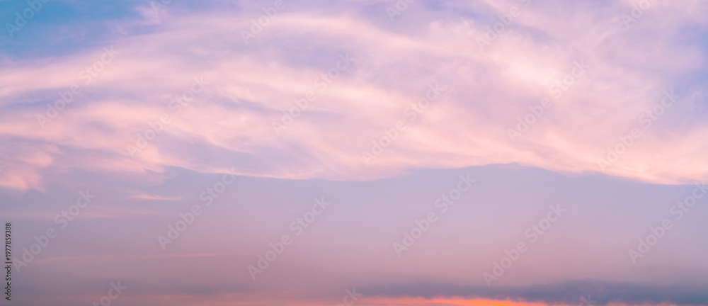 Fototapeta premium Dramatic pink sunset sky with soft clouds forming abstract pastel background in evening, serene nature scene capturing calm relaxing mood and romantic love concept with gentle light and dreamy horizon