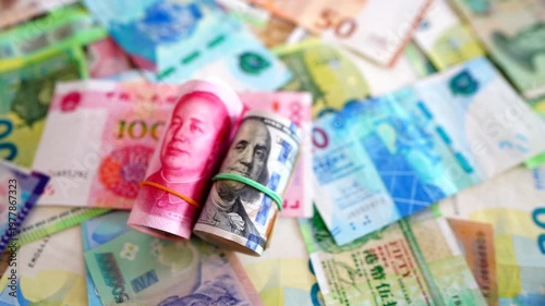 Chinese yuan, US dollars among various currencies background. Banknotes different countries denominations. Chinese yuan, US dollars and foreign currencies. World's reserve currency in global trade.