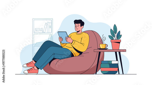 Relaxed man sitting in comfortable beanbag chair while using digital tablet with cup of hot coffee on side table.