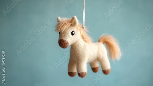 Tiny horse plush hanging on a mobile