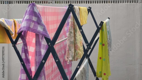 Colorful Laundry Drying On Outdoor Rack Under Bright Sunlight