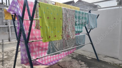 Clothes Drying Rack With Colorful Towels and Blankets Outdoors On A Sunny Day