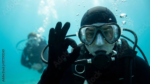 Scuba diver underwater diving mask wetsuit regulator ok sign scuba diver underwater wearing diving mask and wetsuit with regulator, giving ok sign, air bubble blue sea with another diver