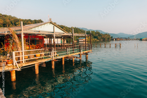 Waterfront wooden stilt houses and homestay over clear tropical sea.