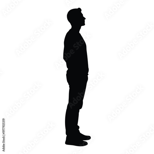 Konstfotografi A full body silhouette of a man standing with his hands in his pockets and looki