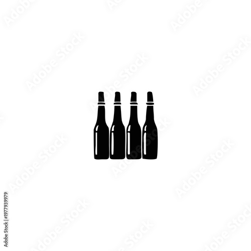 Four dark beer bottles standing together.