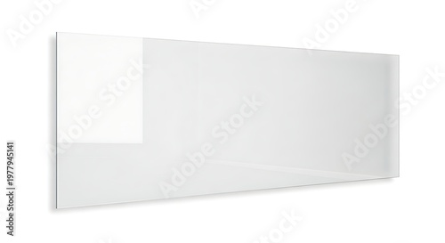 A pristine rectangular white board leans against a white wall offering a blank canvas for ideas and collaboration