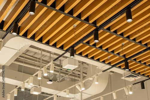 Modern commercial interior ceiling with exposed pipes, LED lighting, air ducts, sprinkler system and CCTV, clean industrial design with structured architecture and lighting layout