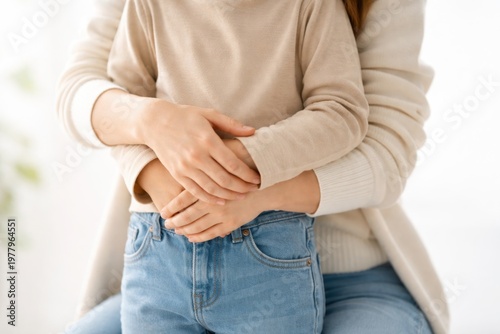 Mother hugging child from behind showing care protection warmth and strong family bond