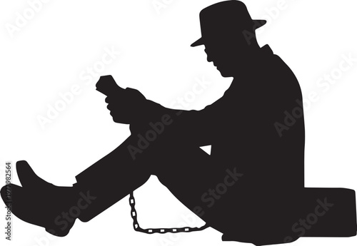 Silhouette of a man in a hat shackled and looking at a phone