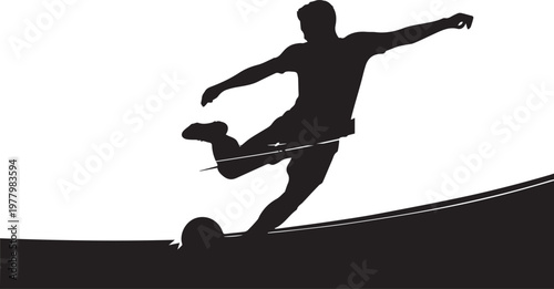 Silhouette of a soccer player kicking a ball football
