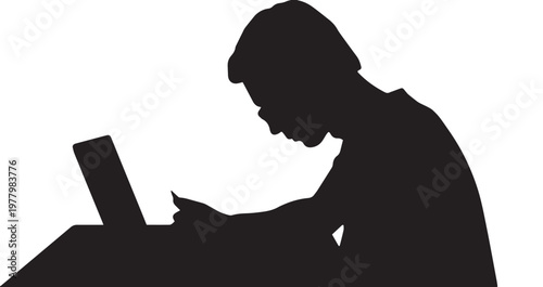 Silhouette of a person working on a laptop at a desk