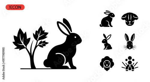 A solid black rabbit sits next to a plant with leaves.