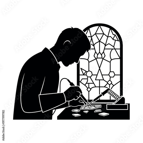 Silhouette of a craftsman soldering stained glass.